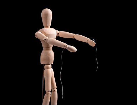 Puppet, marionette with torn strings. Abuse prevention, authority, domination stop. Emancipation from slavery. Freedom concept. Divorce after toxic relationship. High quality photo