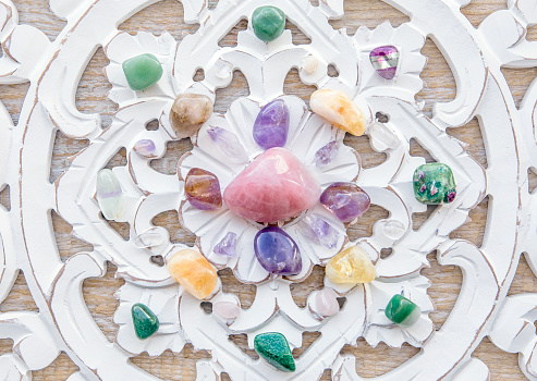 Semi precious stones crystal grid pattern in home helps intentions to manifest concept. Alternative lifestyle. Relaxation and balance, wealth. Above view.