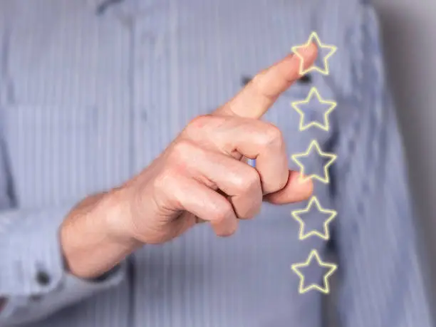 Photo of Man hand giving feedback. Star rating of service quality at virtual screen. Customer satisfaction survey, assessment of consumer experience.