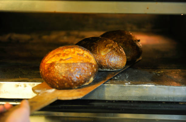 istock Taking sourdough bread out of oven 1401032175