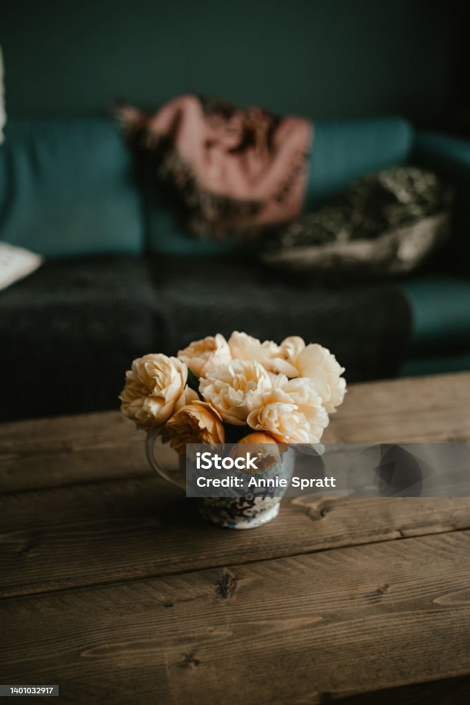 Vase of peach coloured roses in a vase Vase of peach coloured roses on a table top Bouquet Stock Photo