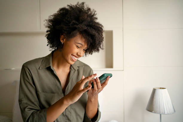 Black woman shopping online at home stock photo