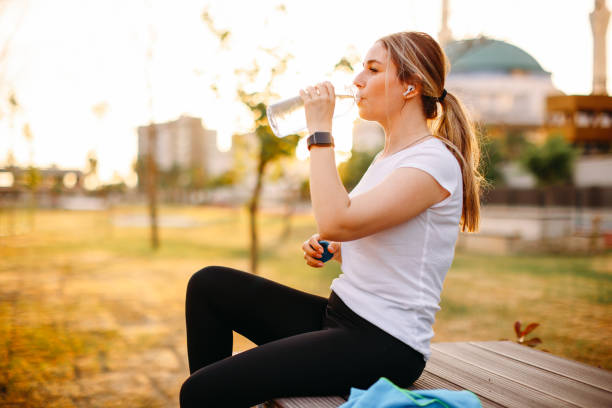istock Woman is refreshed after the training at park 1401042136