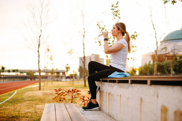 istock Woman is refreshed after the training at park 1401042308