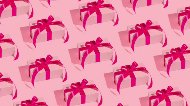 istock Pattern of Christmas gift boxes on pink background 1401043677