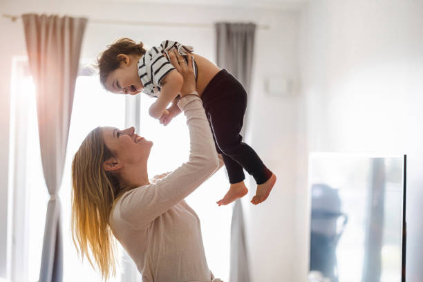 istock Mother playing with her little son at home 1401044233