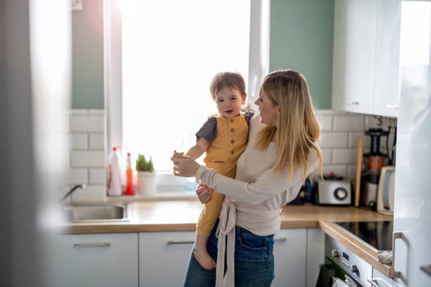 istock Young mother with child in the kitchen 1401044258