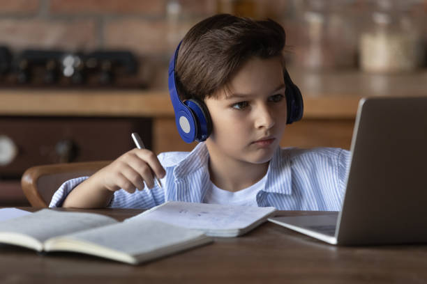 istock Close up little boy in wireless headphones studying online 1401047421