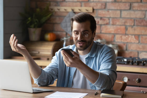 istock Man in glasses holding smartphone, chatting online by video call 1401047432