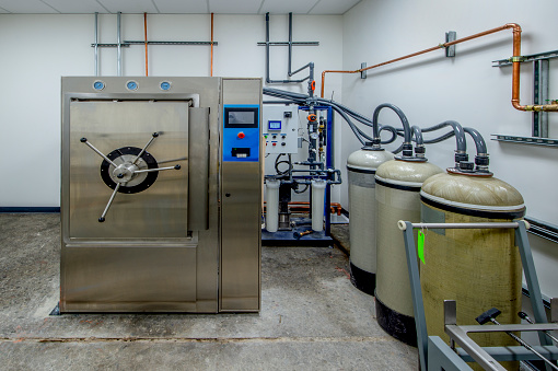 Autoclave with water purification system.