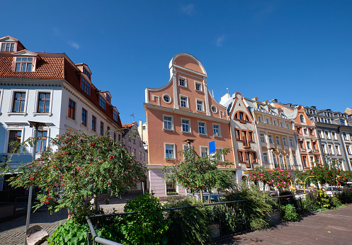Riga old town, Latvia in Summer. Historic houses and plants by street cafe in Old Town, Vecriga.