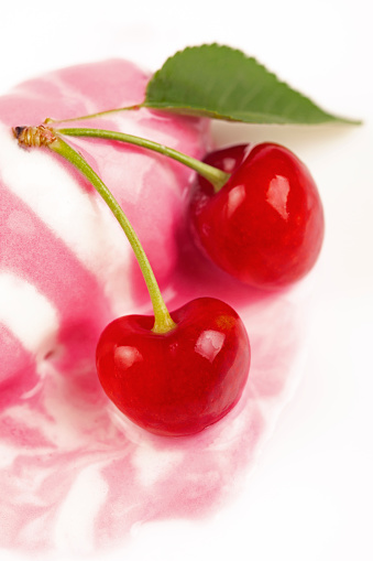Ice cream with cherry on white background