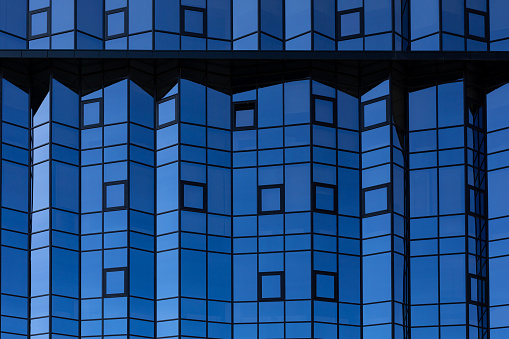 Glass facade of a modern high rise building in vienna close up