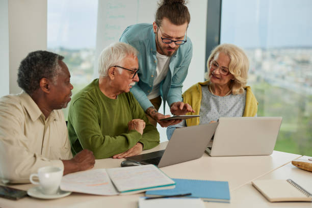 istock Multicultural group of senior students asking questions their tutor who showing them solution. 1401054370