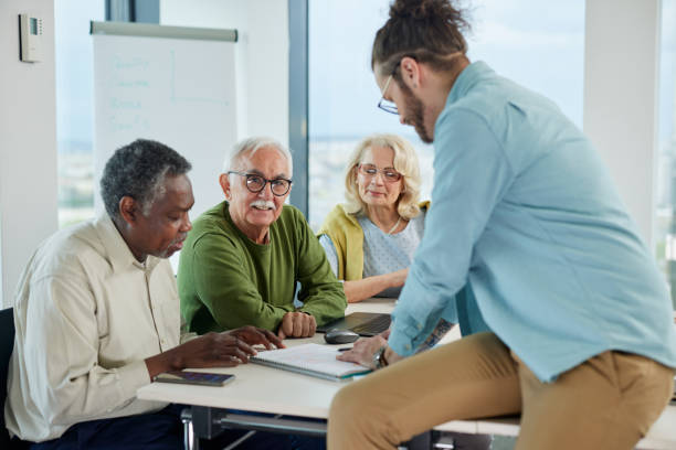 istock Small multiracial group of senior students in a classroom asking for explanation their teacher. 1401054946