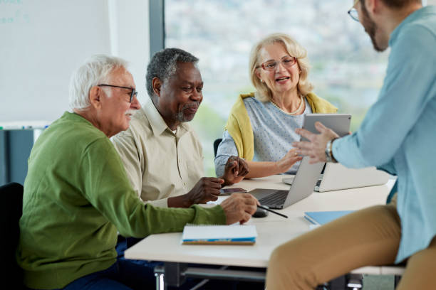 istock Small multiracial group of senior students in a classroom asking for explanation their teacher. 1401054952