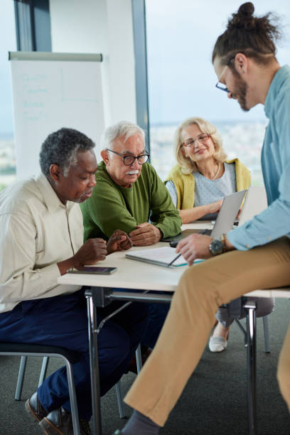 istock Small multiracial group of senior students in a classroom asking for explanation their teacher. 1401054972
