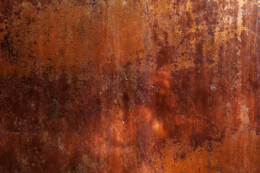A red painted grunge metal texture background, featuring a weathered and worn surface with a rugged appearance