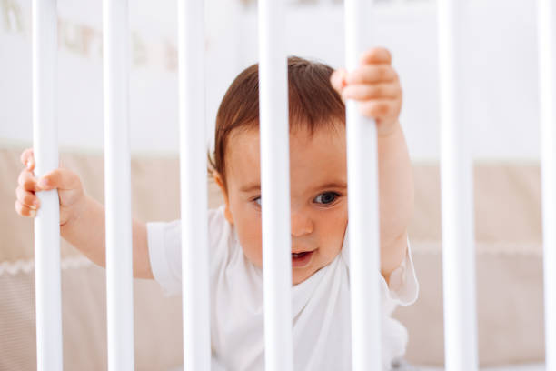 istock Baby boy standing in cot 1401058827