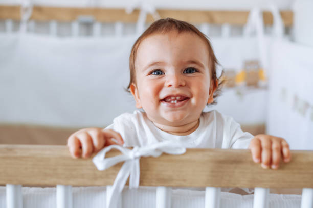 istock Baby boy standing in cot 1401059006