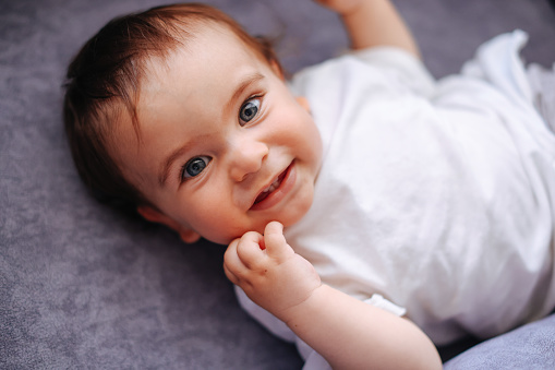 Adorable baby boy  is lying in the bed