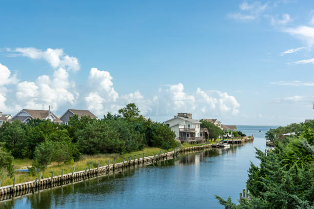Canals on the island of Ocracoke. OCRACOKE, NORTH CAROLINA, AUGUST 15, 2021 - Canals provide access to the Pamlico Sound on the island of Ocracoke, and beach homes line the canals. ocracoke island stock pictures, royalty-free photos & images