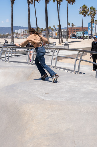 Los Angeles, USA - May 11th, 2022: A Rollerskater ripping at the iconic Venice Beach Skatepark late in the day.