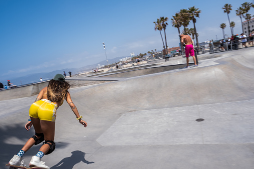 Los Angeles, USA - May 8th, 2022: A skateboarder ripping at the iconic Venice Beach Skatepark late in the day.