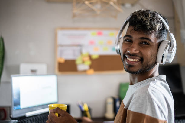 istock Portrait of a young man using laptop working or studying at home 1401068836