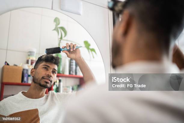 Young Man Brushing Hair With Comb At Bathroom Stock Photo - Download Image Now - Hair, Mirror - Object, Only Men