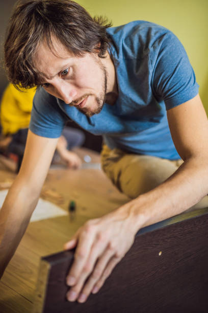 istock Frustrated Man Putting Together Self Assembly Furniture 1401069480