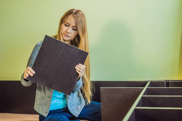 istock Caucasian woman using screwdriver for assembling furniture 1401069494
