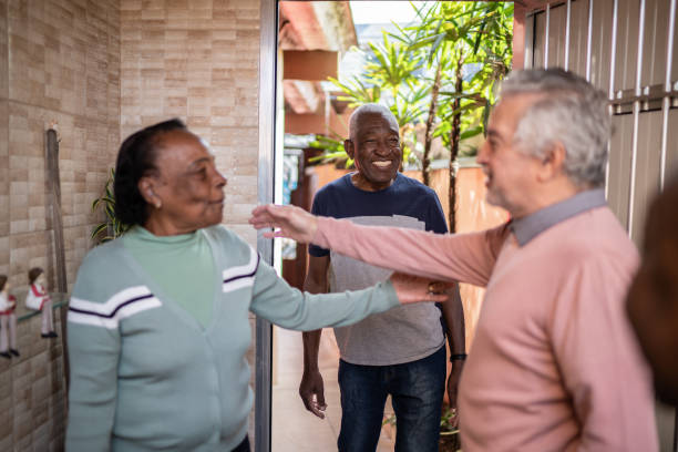 istock Senior friends greeting each other at home 1401069668
