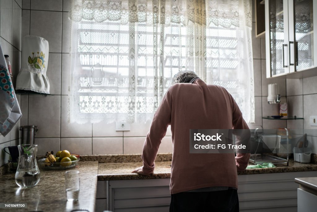 Senior man feeling pain at home Loneliness Stock Photo