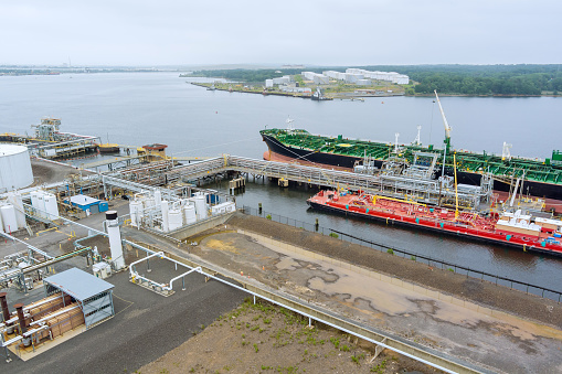 Aerial view at oil terminal commercial port for transfer with logistic industrial crude oil fuel tanker ship