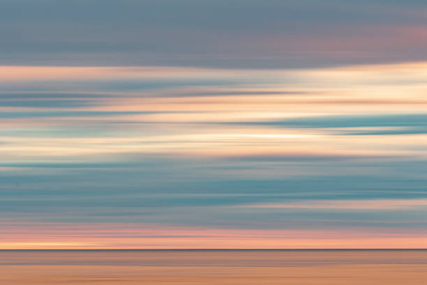 Smooth and calm surface of the ocean during a dramatic golden sunset