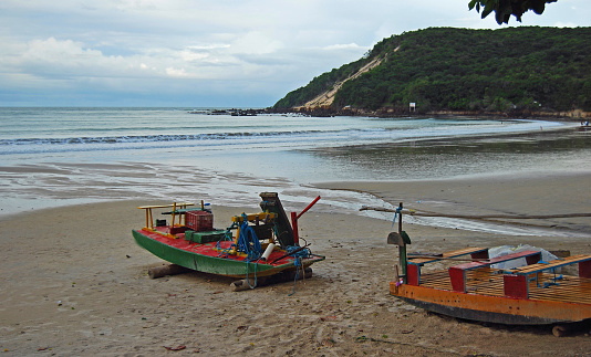 Two fishing boats.  Colorful.  On the beach at Ponta Negra, Natal.  Rio Grande do Norte, Brazil (Brasil).  Early morning.