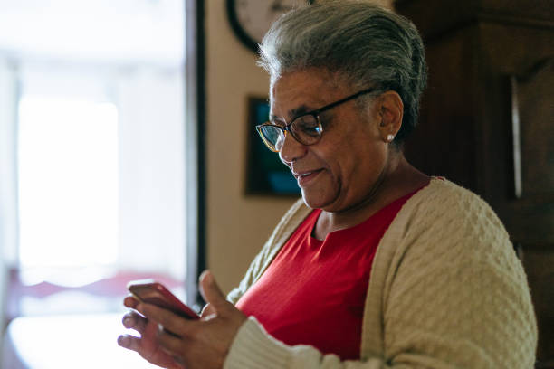 istock Elderly woman using smartphone at home 1401076442