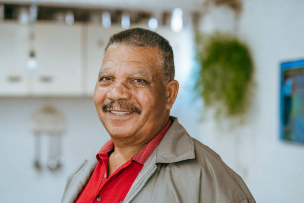 Portrait of a smiling elderly man at home stock photo