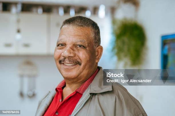 Portrait Of A Smiling Elderly Man At Home Stock Photo - Download Image Now - Men, Senior Adult, Old