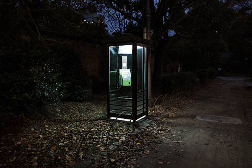 Pay phone by the path at dusk