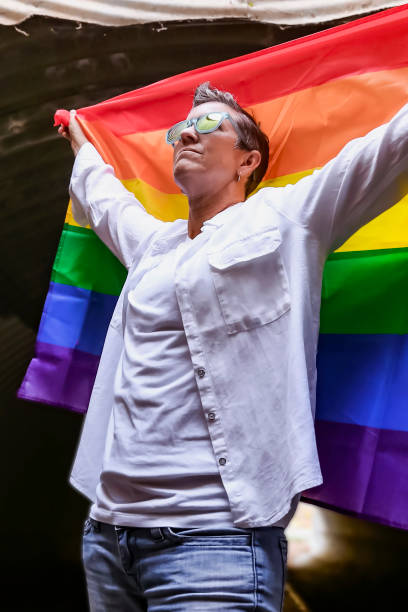 istock LGBTQIA+ Female Identifying holding flag 1401080941