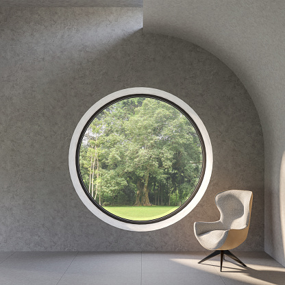 Modern loft style living room with circle shape window 3d render,polished concrete floors. decorated with gray fabric furniture natural view Get sunlight into the room