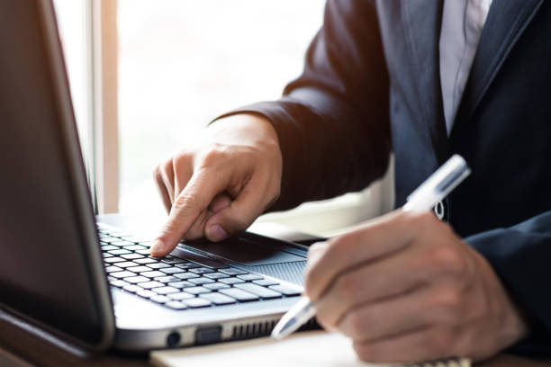 istock businessmen working at their desks with notebooks taking notes Accepting orders from online customers, online business and e-commerce, Online stores selling products. 1401085594