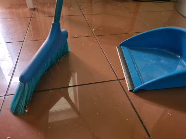 istock Dirt swept with broom lies on tile floor closeup 1401085602