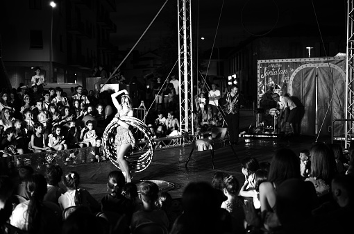 Parabiago, Italy - June 04, 2022:in front of a crowd of adults and children, circus artists perform for free in the main square of Parabiago.