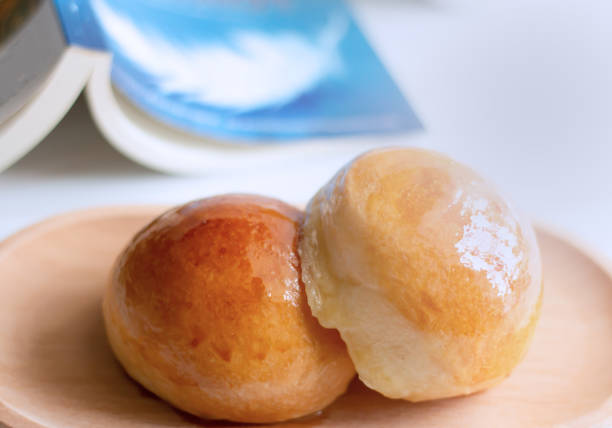 istock Two butter bread bun  on wooden plate with book 1401091286