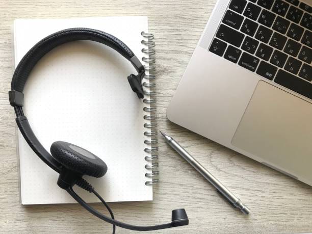 istock Flat lay, top view office table desk. workspace with laptop, headset, pen, and notebook. freelance or remote work concept. 1401097372