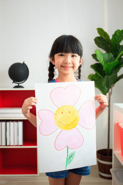 istock Happy little girl showing her drawing. 1401098779
