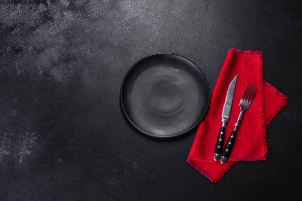 istock Christmas table setting with empty black ceramic plate, fir tree and black accessories 1401099578